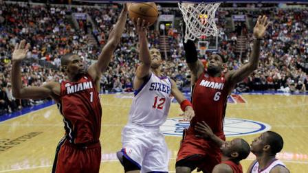 Philadelphia 76ers Evan Turner (12) goes up for a shot between Miami Heats Chris Bosh (1) and LeBron James (6) as Thaddeus Young (21) and Dwyane Wade watch during the second half of an NBA basketball game, Wednesday, March 13, 2013, in Philadelphia. Miami won 98-94. (AP Photo/Matt Slocum)