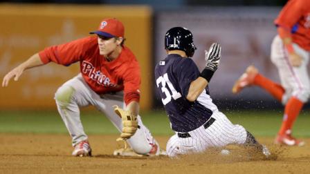 Philadelphia Phillies second baseman Chase Utley, left, cannot make the play as New York Yankees Ichiro Suzuki (31) steals second in the fourth inning of the Yankees 6-2 victory in a spring training baseball game in Tampa, Fla., Wednesday, March 13, 2013. (AP Photo/Kathy Willens)
