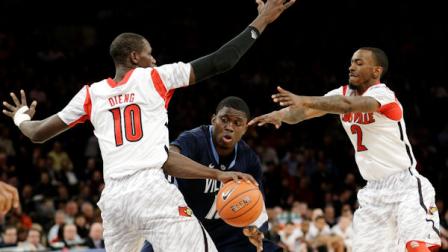 Villanovas Mouphtaou Yarou (13) is defended by Louisvilles Gorgui Dieng (10) and Russ Smith (2) during the second half of an NCAA college basketball game at the Big East Conference tournament, Thursday, March 14, 2013, in New York. (AP Photo/Frank Franklin II)