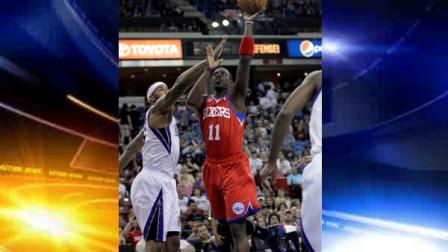 Philadelphia 76ers guard Jrue Holiday, right, drives to the basket against Sacramento Kings center DeMarcus Cousins during the first quarter of an NBA basketball game in Sacramento, Calif., Sunday, March 24, 2013.(AP Photo/Rich Pedroncelli)