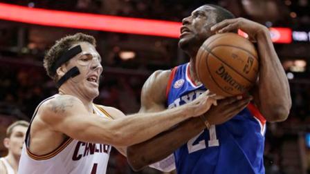 Cleveland Cavaliers Luke Walton (4) fouls Philadelphia 76ers Thaddeus Young (21) during the first quarter of an NBA basketball game Friday, March 29, 2013, in Cleveland. (AP Photo/Tony Dejak)