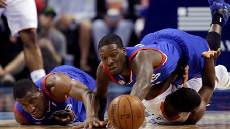 Philadelphia 76ers Thaddeus Young, left, watches as teammate Royal Ivey, top right, stretches over Charlotte Bobcats Kemba Walker for a loose ball during the second half of an NBA basketball game in Charlotte, N.C., Wednesday, April 3, 2013. The Bobcats won 88-83. (AP Photo/Bob Leverone)