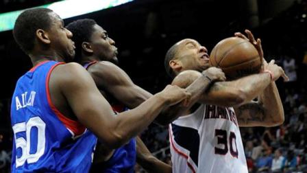 Atlanta Hawks forward Dahntay Jones (30), is fouled by Philadelphia 76ers guard Justin Holiday as center Lavoy Allen (50) also defends during the first half of a basketball game, Friday, April 5, in Atlanta. (AP Photo/John Amis)