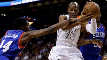 Miami Heats Ray Allen (34) fights for a rebound with Philadelphia 76ers Justin Holiday (14) in the first half of an NBA basketball game, Saturday, April 6, 2013, in Miami. (AP Photo/Lynne Sladky)