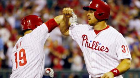 Philadelphia Phillies Laynce Nix and Erik Krantz celebrate Nix two-run home run that scored Krantz during the sixth inning of a baseball game against the New York Mets, Wednesday, April 10, 2013, in Philadelphia. The Phillies won 7-3. (AP Photo/Tom Mihalek)