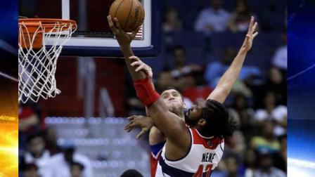 Washington Wizards center Nene, right, drives to the basket against Philadelphia 76ers center Spencer Hawes during the first half of an NBA basketball game on Friday, April 12, 2013, in Washington. (AP Photo/Evan Vucci)