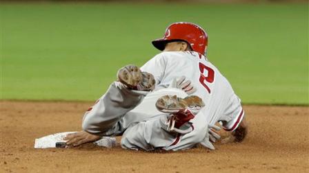 Philadelphia Phillies Ben Revere (2) steals second base against the Miami Marlins during the fifth inning of a baseball game in Miami, Sunday, April 14, 2013. (AP Photo/Alan Diaz)