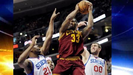 Cleveland Cavaliers Alonzo Gee (33) looks for room to shoot as Philadelphia 76ers Thaddeus Young (21) and Spencer Hawes (00) defend during the first half of an NBA basketball game, Sunday, April 14, 2013, in Philadelphia. (AP Photo/Michael Perez)