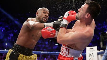 Floyd Mayweather Jr., left, lands a punch against Robert Guerrero in the fourth round during a WBC welterweight title fight, Saturday, May 4, 2013, in Las Vegas. Mayweather won by unanimous decision. (AP Photo/Rick Bowmer)