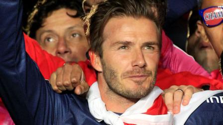 Paris Saint-Germains midfielder David Beckham from England, watches supporters as he celebrates PSGs French League One title, at the Parc des Princes stadium, in Paris, Saturday, May 18, 2013. This match was his final home game for Paris Saint-Germain before retirement. (AP Photo/Thibault Camus)