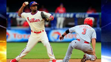 Cincinnati Reds Cesar Izturis (3) is forced out at second as Philadelphia Phillies Jimmy Rollins throws to first to complete the double play during the third inning of a baseball game on Sunday, May 19, 2013, in Philadelphia. (AP Photo/Tom Mihalek)