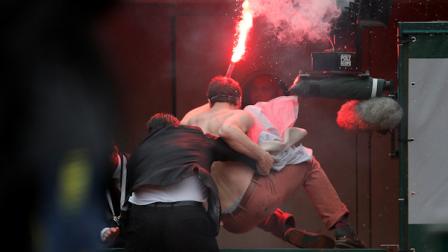A security guard removes a demonstrator who ran onto center court as Spains Rafael Nadal plays against compatriot David Ferrer in the final of the French Open tennis tournament, at Roland Garros stadium in Paris, Sunday June 9, 2013. (AP Photo/Michel Spingler)