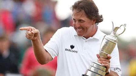 Phil Mickelson of the United States gestures as he holds the Claret Jug trophy after winning the British Open Golf Championship at Muirfield, Scotland, Sunday July 21, 2013. (AP Photo/Matt Dunham)