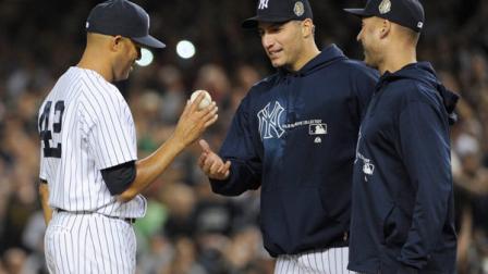 New York Yankees relief pitcher Mariano Rivera, left, hands the ball to Andy Pettitte as Derek Jeter, right, watches during the ninth inning of a baseball game against the Tampa Bay Rays on Thursday, Sept. 26, 2013, at Yankee Stadium in New York. The Yankees lost to the Rays 4-0 in Riveras final home game with the team. (AP Photo/Bill Kostroun)