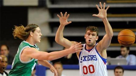 Boston Celtics forward Kelly Olynyk (41) passes against Philadelphia 76ers center Spencer Hawes (00) in the first quarter of a preseason NBA basketball game Friday, Oct. 11, 2013, in Newark, Del. The 76ers won 97-85. (AP Photo/Steve Ruark)
