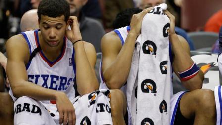 Philadelphia 76ers Evan Turner, right, and Michael Carter-Williams sit on the bench during an NBA basketball game against the San Antonio Spurs, Monday, Nov. 11, 2013, in Philadelphia. (AP Photo/Matt Slocum)