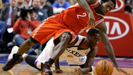 Houston Rockets Patrick Beverley (2) and Philadelphia 76ers Tony Wroten (8) chase down a loose ball during the second period of an NBA basketball game, Wednesday, Nov. 13, 2013, in Philadelphia. Philadelphia won 123-117 in overtime. (AP Photo/Matt Slocum)