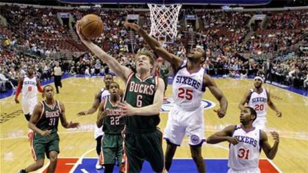 Milwaukee Bucks Nate Wolters (6) goes up to shoot as Philadelphia 76ers Elliot Williams (25) defends during the first half of an NBA basketball game on Friday, Nov. 22, 2013, in Philadelphia. (AP Photo/Matt Slocum)