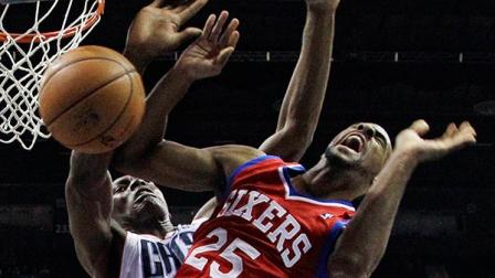 Philadelphia 76ers Elliot Williams, front, is fouled by Charlotte Bobcats Bismack Biyombo, back, during the first half of an NBA basketball game in Charlotte, N.C., Friday, Dec. 6, 2013. (AP Photo/Chuck Burton)