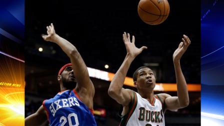 Milwaukee Bucks Giannis Antetokounmpo and Philadelphia 76ers Brandon Davies go after a loose ball during the first half of an NBA basketball game Saturday, Dec. 21, 2013, in Milwaukee. (AP Photo/Morry Gash)