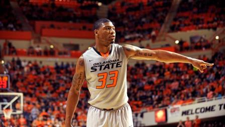 FILE - Oklahoma State guard Marcus Smart points during an NCAA college basketball game in Stillwater, Okla., Saturday, Feb. 1, 2014. (AP Photo/Brody Schmidt)