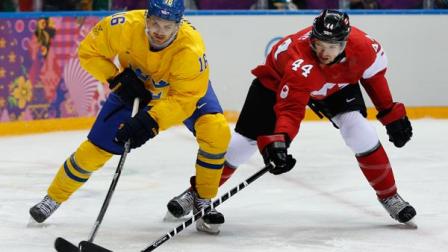 Canada defenseman Marc-Edouard Vlasic, right, takes the puck from Sweden forward Marcus Kruger of the mens gold medal ice hockey game at the 2014 Winter Olympics, Sunday, Feb. 23, 2014, in Sochi, Russia. (AP Photo/Julio Cortez)