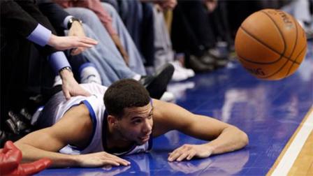 Philadelphia 76ers Michael Carter-Williams looks on from the court after he tried to save the ball form going out of bounds during the first half of an NBA basketball game against the Milwaukee Bucks, Monday, Feb. 24, 2014, in Philadelphia. (AP Photo/Chris Szagola)