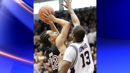 Temples Aaron Brown (22) shoots the ball over George Washingtons Jabari Edwards (13) during the first half of an NCAA basketball game Saturday, Feb. 26, 2011, in Washington. (AP Photo/Luis M. Alvarez)