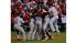 The St. Louis Cardinals react after winning with...