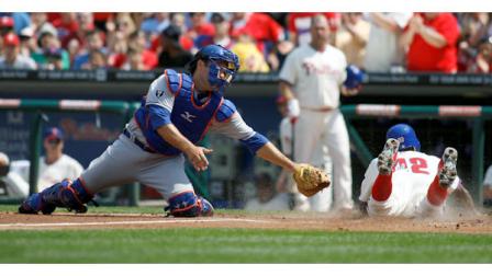 New York Mets Mike Nickeas, left, moves for a late tag as Philadelphia Phillies Juan Pierre scores in the first inning of a baseball game on Sunday, April 15, 2012, in Philadelphia. (AP Photo/H. Rumph Jr)