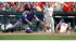 New York Mets Mike Nickeas, left, moves for a...