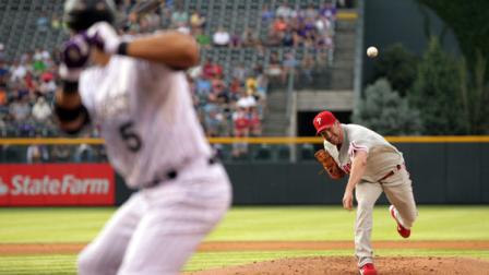 Philadelphia Phillies starting pitcher Cliff Lee, right, delivers a pitch to Colorado Rockies Carlos Gonzalez in the first inning of a baseball game in Denver on Friday, July 13, 2012. (AP Photo/Joe Mahoney)