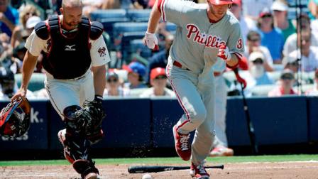 Atlanta Braves catcher David Ross watches a bunt by Philadelphia Phillies Roy Halladay roll foul during the third inning of their baseball game, Sunday, July 29, 2012, in Atlanta. (AP Photo/David Tulis)