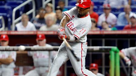 Philadelphia Phillies Jimmy Rollins hits a solo home run during the first inning of a baseball game against the Miami Marlins, Tuesday, Aug. 14, 2012, in Miami. (AP Photo/Wilfredo Lee)