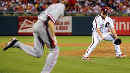 Philadelphia Phillies Vance Worley, right, drops a ball bunted by Cincinnati Reds Bronson Arroyo, left, in the sixth inning of a baseball game, Wednesday, Aug. 22, 2012, in Philadelphia. The Reds won 3-2. (AP Photo/Michael Perez)