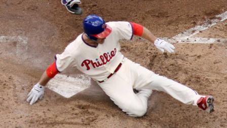 Philadelphia Phillies Chase Utley, bottom, scores past Colorado Rockies catcher Wilin Rosario on a two-run double by Ryan Howard in the third inning of the first game of a baseball doubleheader on Sunday, Sept. 9, 2012, in Philadelphia.