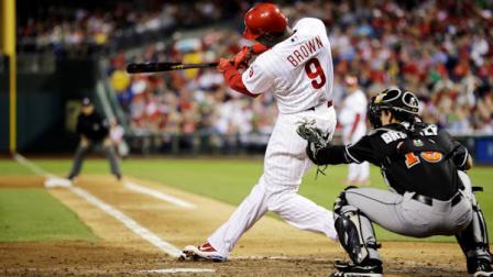 Philadelphia Phillies Domonic Brown hits a two-run home run off Miami Marlins starting pitcher Wade LeBlanc in the fifth inning of a baseball game, Monday, Sept. 10, 2012, in Philadelphia. At right is Marlins catcher Rob Brantly. Philadelphia won 3-1. (AP Photo/Matt Slocum)