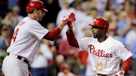 Philadelphia Phillies Jimmy Rollins, right, and Roy Halladay celebrate after Rollins two-run home run off Miami Marlins relief pitcher Chris Hatcher in the fifth inning of a baseball game, Tuesday, Sept. 11, 2012, in Philadelphia. Philadelphia won 9-7. (AP Photo/Matt Slocum)