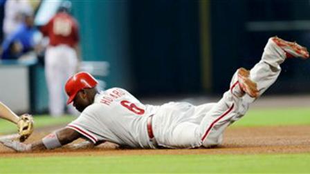 Philadelphia Phillies Ryan Howard (6) is tagged out by Houston Astros third baseman Matt Dominguez, left, while trying to stretch a double into a triple during the fifth inning of a baseball game, Sunday, Sept. 16, 2012, in Houston. Two runs scored on Howards double. (AP Photo/David J. Phillip)