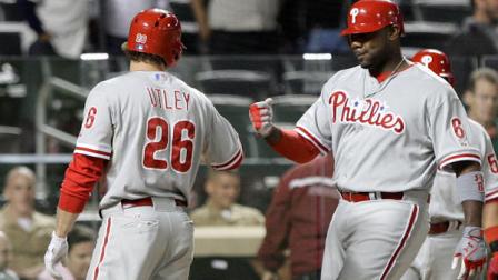 Philadelphia Phillies Ryan Howard (6) celebrates with teammate Chase Utley (26) after hitting a two-run home run during the ninth inning of a baseball game against the New York Mets, Wednesday, Sept. 19, 2012, in New York. (AP Photo/Frank Franklin II)