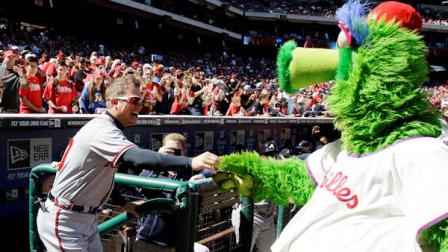 Atlanta Braves Chipper Jones, left, laughs as he returns keys to the Philadelphia Phillies mascot, the Phillie Phanatic, after Jones stole them from the Phanatics all-terrain vehicle before a baseball game between the Phillies and Braves, Sunday, Sept. 23, 2012, in Philadelphia. (AP Photo/Matt Slocum)