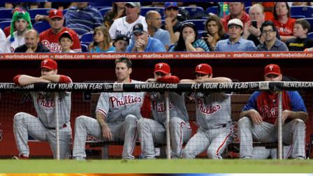 Philadelphia Phillies players watch the final seconds of the baseball game against the Miami Marlins in Miami, Friday, Sept. 28, 2012. The Marlins won 2-1, and the Phillies were eliminated from playoff contention. (AP Photo/Alan Diaz)