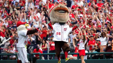 Teddy Roosevelt, one of the Washington Nationals racing president, celebrates after crossing the finish line winning the Presidents Race for the first time in the events seven year history at Nationals Park during a baseball game between the Washington Nationals and Philadelphia Phillies in Washington, Wednesday, Oct. 3, 2012. (AP Photo/Manuel Balce Ceneta)