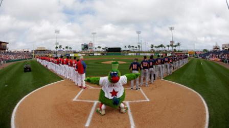 In this image taken with a fisheye lens, the Philadelphia Phillies mascot, the Phillie Phanatic, reacts after the playing of the national anthem before the start of an exhibition spring training baseball game between the Phillies and the Houston Astros, Saturday, Feb. 23, 2013, in Clearwater, in Fla. (AP Photo/Matt Slocum)