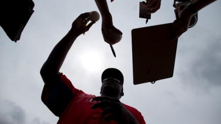 Philadelphia Phillies Ryan Howard signs autographs before the start of an exhibition spring training baseball game against the Atlanta Braves on Monday, March 18, 2013, in Kissimmee, Fla. (AP Photo/Evan Vucci)