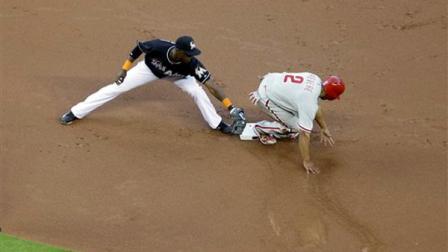 Miami Marlins Adeiny Hechavarria reaches to tag Philadelphia Phillies runner Ben Revere (2) as he slides into second safe during the first inning of a baseball game in Miami, Friday, April 12, 2013. (AP Photo/J Pat Carter)