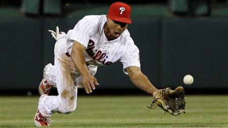 Philadelphia Phillies center fielder Ben Revere dives for a fly-out by St. Louis Cardinals Pete Kozma during the sixth inning of a baseball game on Friday, April 19, 2013, in Philadelphia. (AP Photo/Matt Slocum)