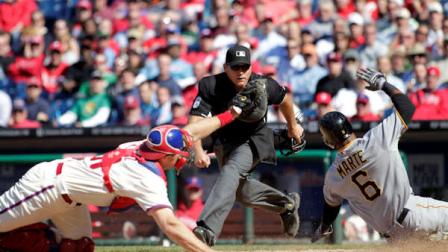 Pittsburgh Pirates Starling Marte (6) is safe at home as Philadelphia Phillies catcher Erik Kratz, left, misses the tag in the eight inning of a baseball game on Thursday, April 25, 2013, in Philadelphia. Home plate umpire Mark Carlson, center, watches the play. The Pirates won 6-4. (AP Photo/H. Rumph Jr)