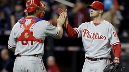 Philadelphia Phillies catcher Erik Kratz, left, and starting pitcher Kyle Kendrick, right, celebrate after Kendrick pitched a complete baseball game 4-0 shutout of the New York Mets at Citi Field in New York, Friday, April 26, 2013. (AP Photo/Kathy Willens)