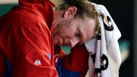 Philadelphia Phillies starting pitcher Roy Halladay wipes his head in the dugout in the fourth inning of a baseball game against the Cleveland Indians, Tuesday, April 30, 2013, in Cleveland. (AP Photo/Tony Dejak)